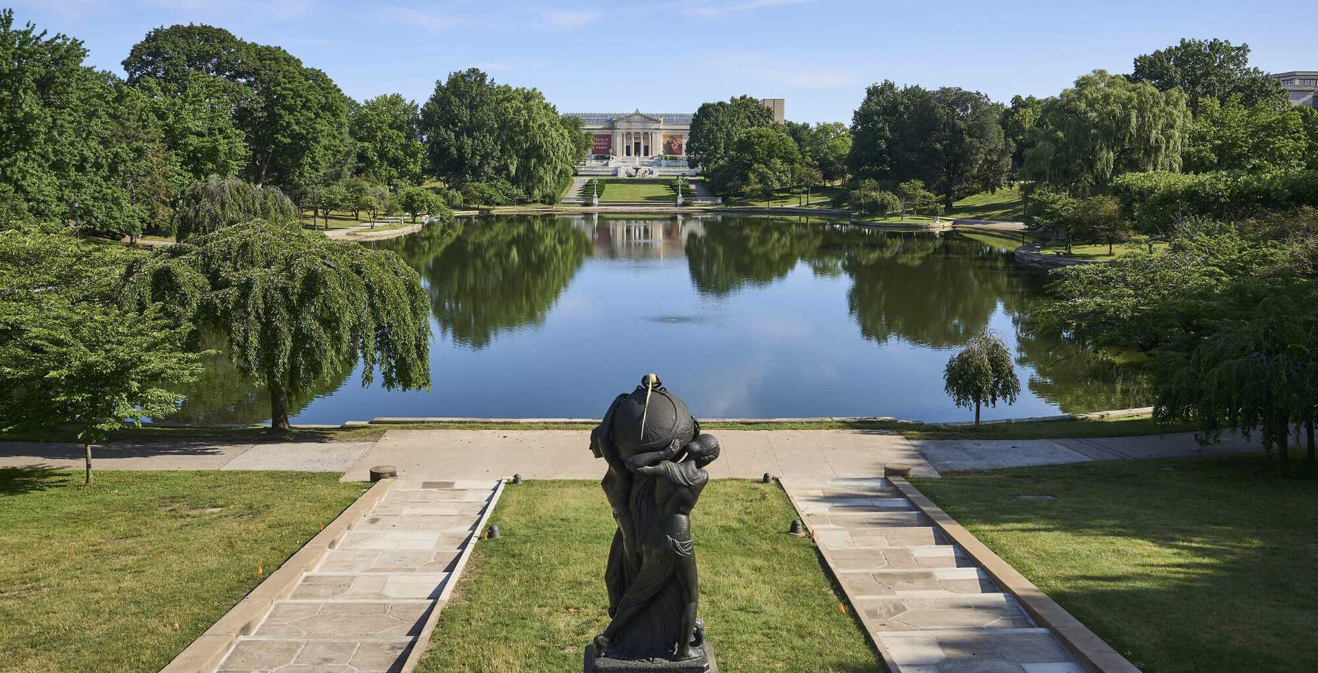 Photo of the Wade Lagoon near Cleveland Museum of Art with a statue in the foreground